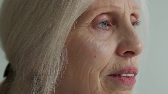 Happy Elderly Woman with Gray Hair Looking Away Dreams of Enjoying the Concept of Retirement Life