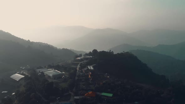 Aerial flight early morning above mountain valley