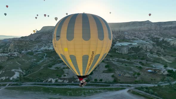 4K Aerial view of Goreme. Colorful hot air balloons fly over the valleys.