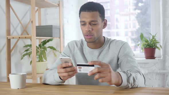 Online Shopping on Smartphone By AfroAmerican Man Payment