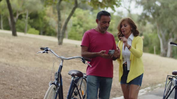 Caucasian Couple Looking at Mobile Screen and Gesticulating