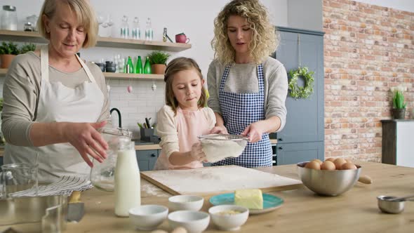 Video of women sift the flour for easter bake. Shot with RED helium camera in 8K.