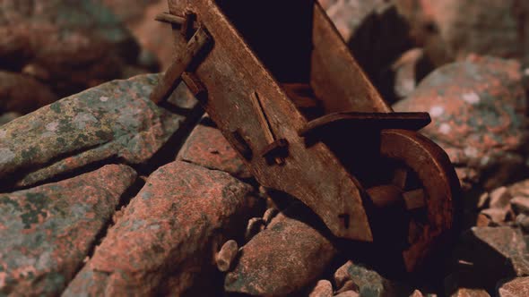 Abandoned Wooden Mine Wheelbarrow on Rocks alt