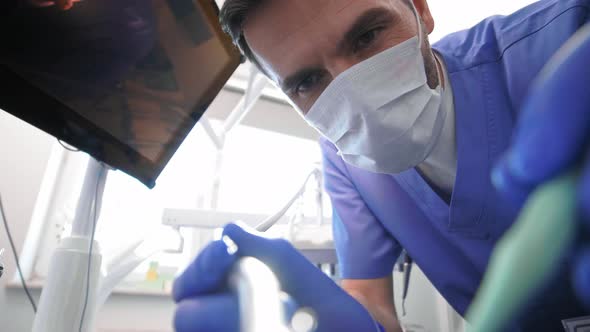 Low angle view of dentist doing his work