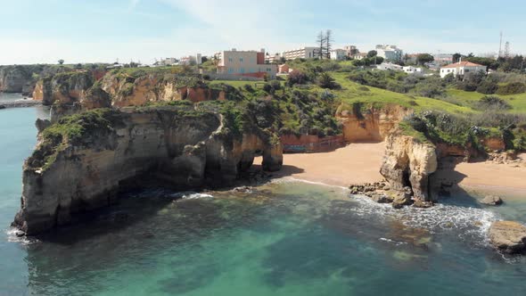 Little Estudante Beach surrounded by rock formations near Lagos, Algarve, Portugal