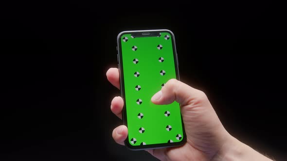 Closeup of a Man Hand Holding Green Mockup Chroma Key Screen Smartphone