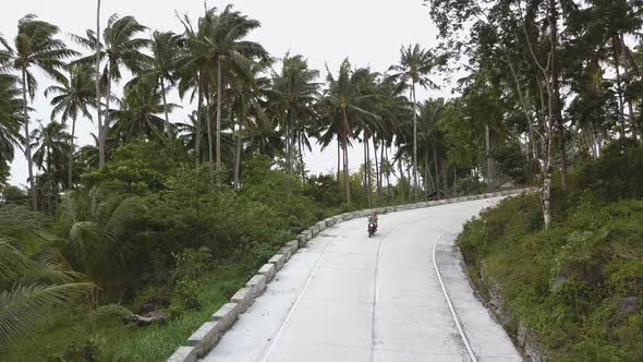 Man Riding Scooter Through Jungles