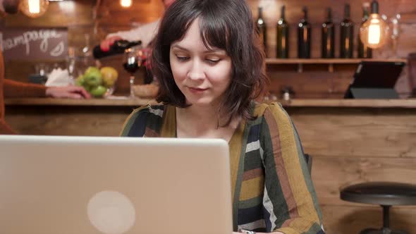 Pretty Young Female Blogger Working in a Cafe Environment