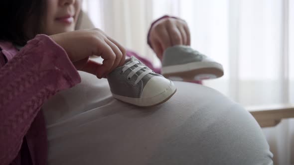 Happy Pregnant Woman and Expecting Baby at Home