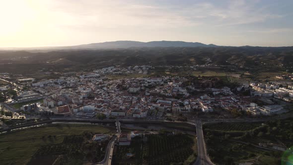 Backwards aerial across the Arade river next to the city of Silves in Portugal