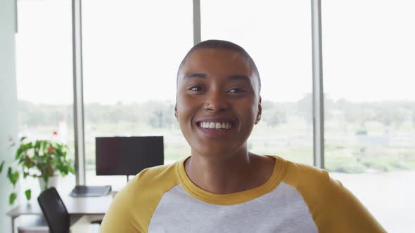 Portrait of smiling african american creative businesswoman in modern office interior