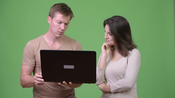 Young Couple Using Laptop and Thinking Together