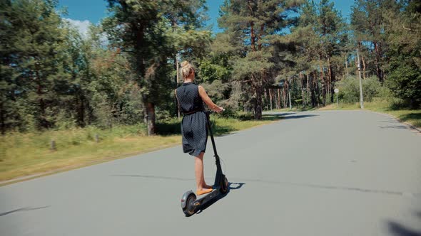 Woman Ride On Electric Scooter Mobility.E-Scooter Rider Rent Personal Eco Transport.
