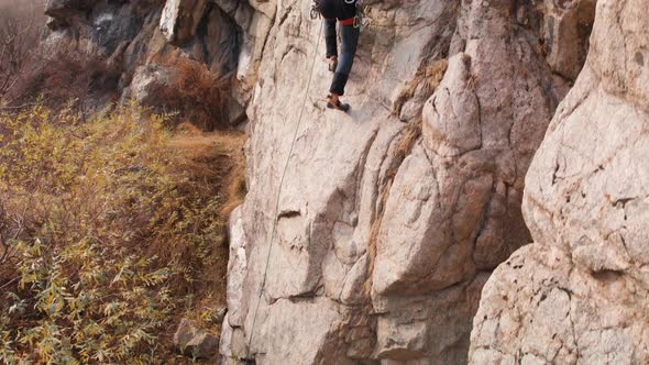 Man Athlette Climbing on the High Rock