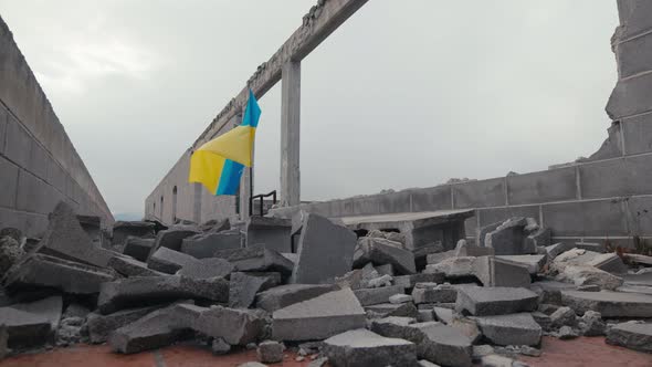 Waving Ukraine Flag on the Building Destroyed in War By Russia
