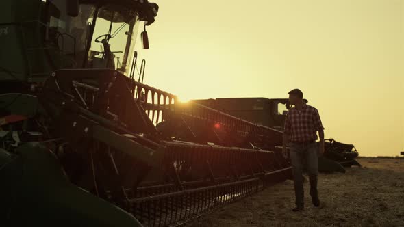 Farmer Walking Combine Harvester Working on Beautiful Countryside Field