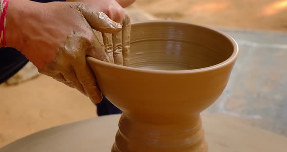 Skilled Hands of Potter Shaping the Clay on Potter Wheel and Sculpting Clay Pot Jar. Shilpagram