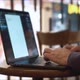 Man Working on Laptop in a Coffee Shop - VideoHive Item for Sale