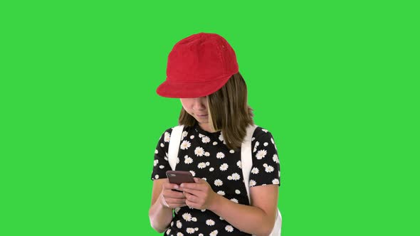 School Girl Checking Her Mobile Phone on a Green Screen Chroma Key