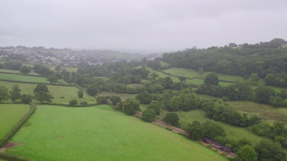 Establishing shot Launceston in Cornwall on a foggy morning, the local steam train heads towards the