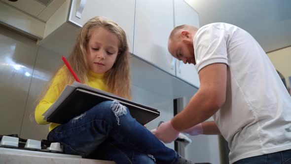 Dad with His 5 Years Old Kid Girl Draw in the Kitchen Casual Lifestyle Photo Series