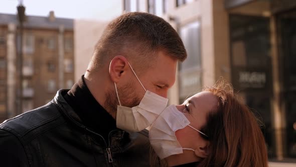 Closeup of a Man in a Protective Medical Mask Embraces His Beloved Girl