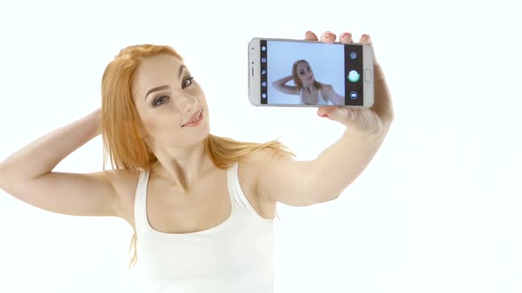 Cute Redhead Girl Doing Selfie on Your Smartphone. White Background