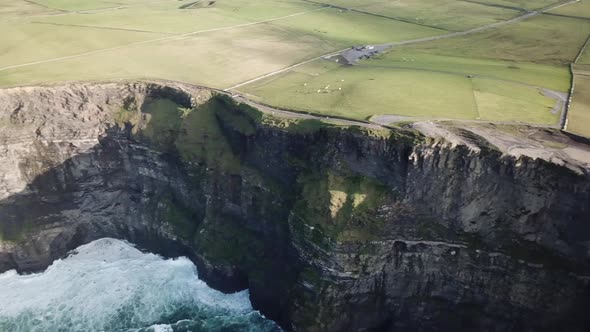 Panning drone shot of Moher cliffs next to the atlantic ocean, Ireland