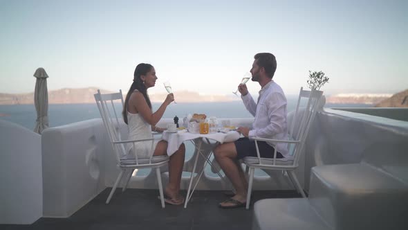 Couple Enjoying Breakfast Outside on Veranda