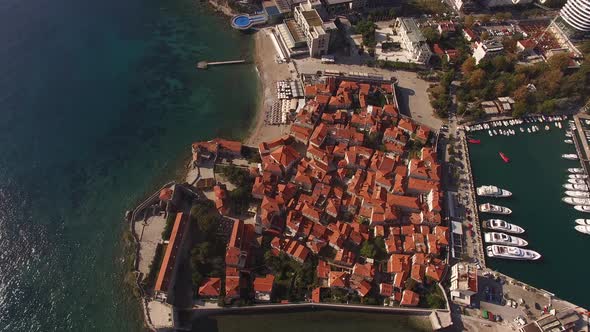 Red Roofs of Old Houses in Budva Against the Background of the Pier