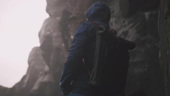 Back View Shot of Young Man with Leather Bagpack Near the Powerful Waterfall in Iceland Cinematic