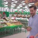 Attractive young man dancing with fresh fruits in supermarket - VideoHive Item for Sale