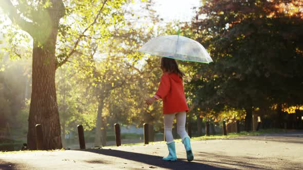 Girl having fun outdoors with umbrella