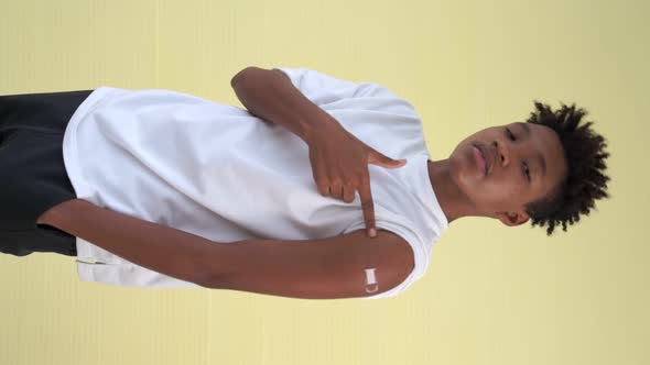 Vertical Video of African Teenager Showing COVID19 Vaccine Bandage Merrily