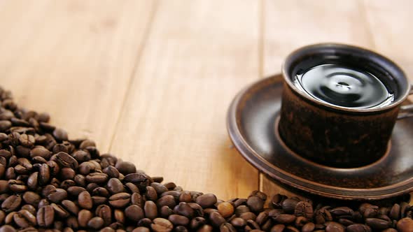 Cup of coffee with roasted beans