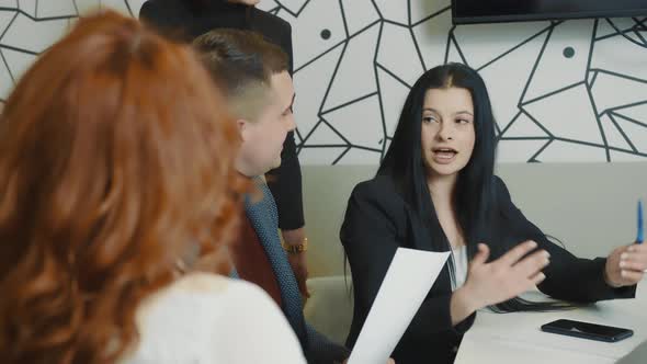 Woman Who Talks About a New Startup During a Meeting with Partners