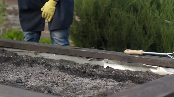 Close Up Female Gardener Working in Garden, Watering Bed with Planted Seeds