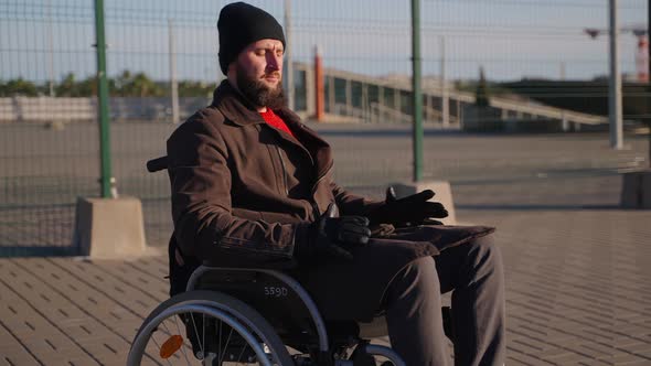 Person with Disease and Immobility of Lower Body is Resting on Street