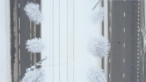 Aerial Top Down View of Snowy City Asphalt Road Landscapes in Winter