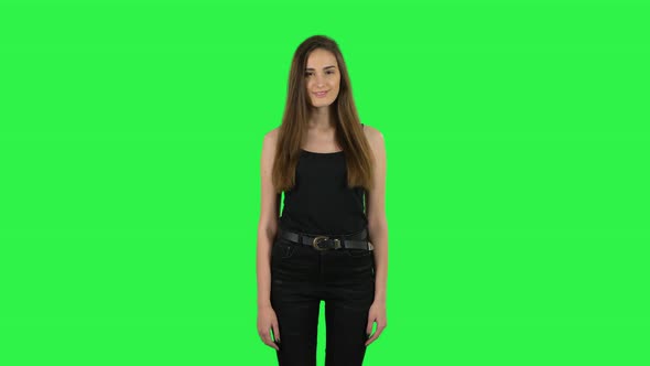 Woman Standing, Spreads Out in a Smile and Looks at the Camera. Green Screen