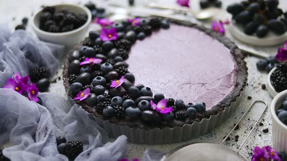 Homemade Blackberry Tart. Sweet Pie with Blackberrym Blueberry and Grapes on Stone Table