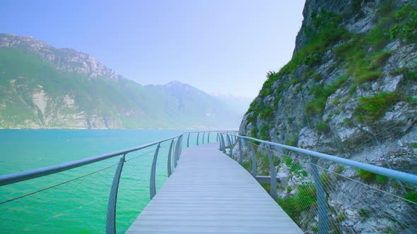 Moving Forward on the Bike Path Between Mountains on the Lake