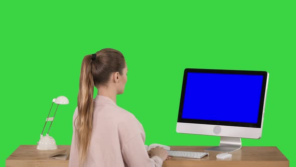 Attractive Casual Businesswoman Working at Office Using Pc Blue Screen Mock-up Display on a Green