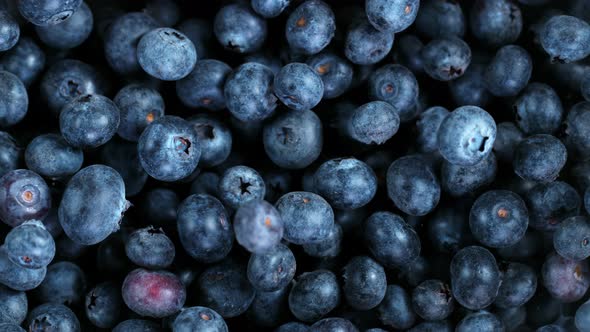 Super Slow Motion Shot of Flying and Rotating Fresh Blueberries at 1000Fps