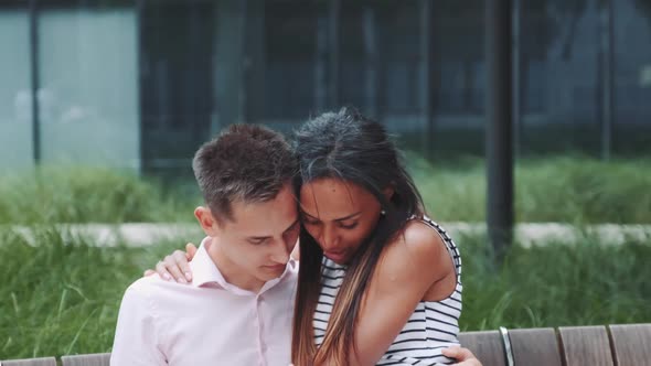 Romantic Mixed-race Couple Hugging and Stroking Each Other Outdoors