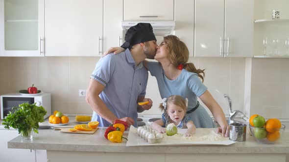 Happy Young Family Spending Time in The Kitchen