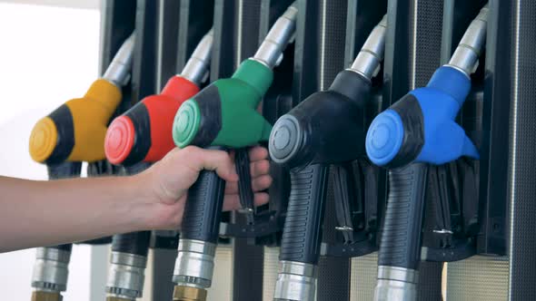 Petrol Pistol Is Getting Taken Out From the Gas Pump By a Man