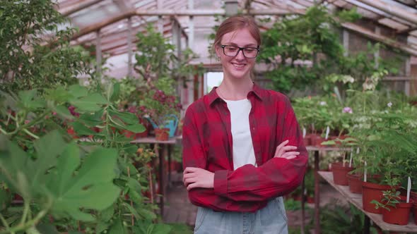 Portrait of a Young Worker of a Greenhouse in Which Flowers and Plants are Grown the Girl Inspector