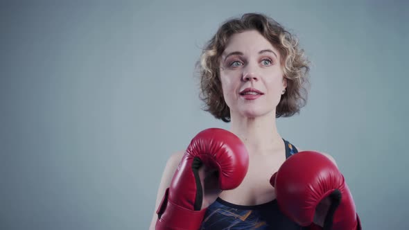 Beautiful Sporty Woman Posing Wearing Boxing Gloves