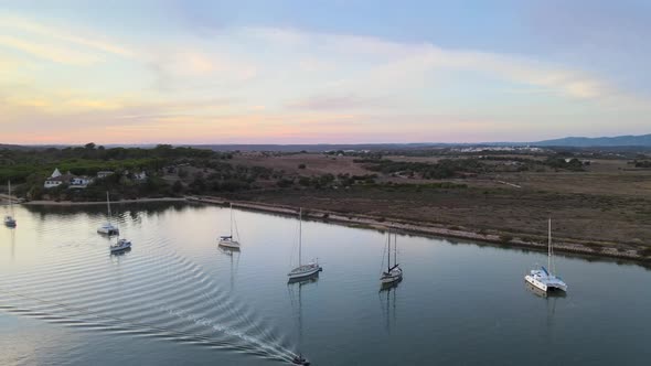 Aerial view of group of sailboats anchoring in Alvor Bay
